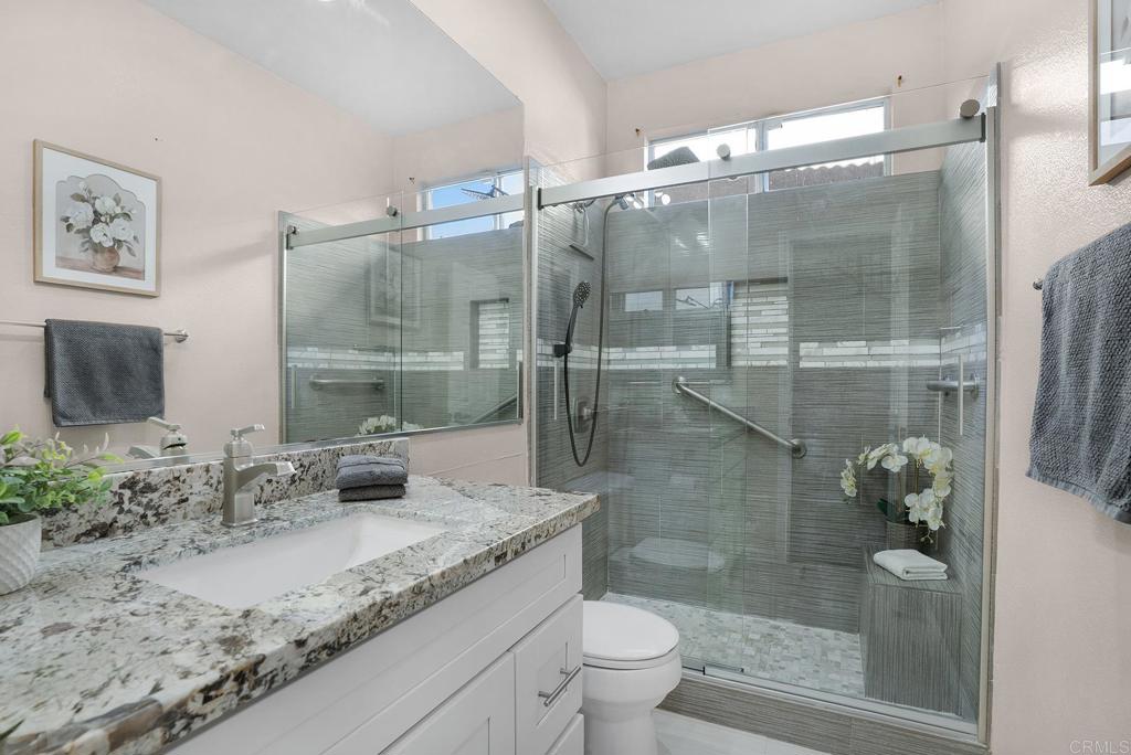 1777 Clover Tree Court Chula Vista, CA 91913 - Photo 33 of 49 a bathroom with a granite countertop sink a toilet and shower