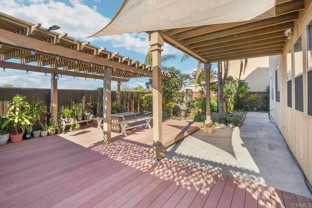 a view of a patio with a table and chairs under an umbrella