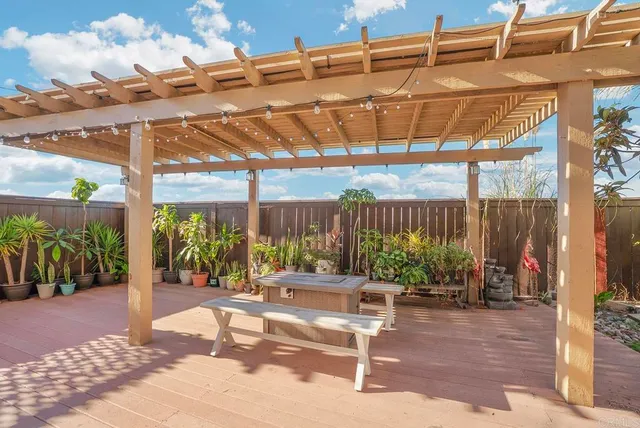 a patio with glass top table and chairs