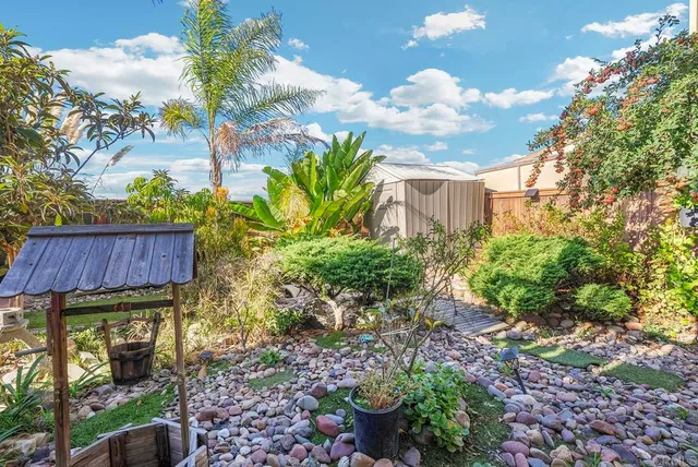 a view of a house with a flower garden