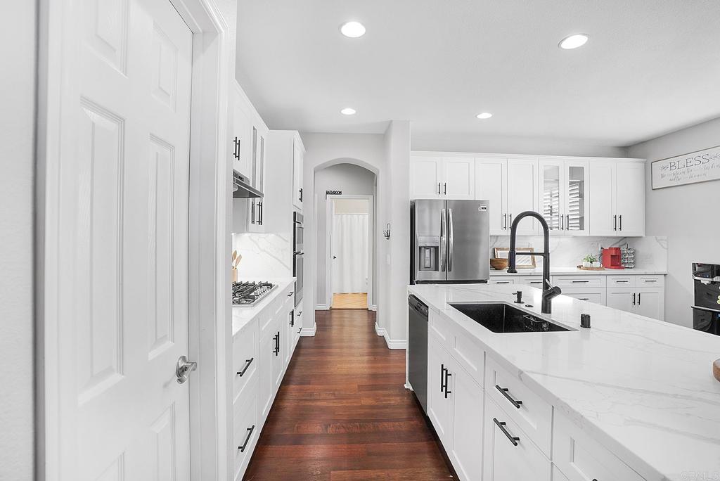 1777 Clover Tree Court Chula Vista, CA 91913 - Photo 10 of 49 a large white kitchen with a sink and cabinets