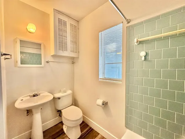 a white toilet sitting next to a bathroom sink