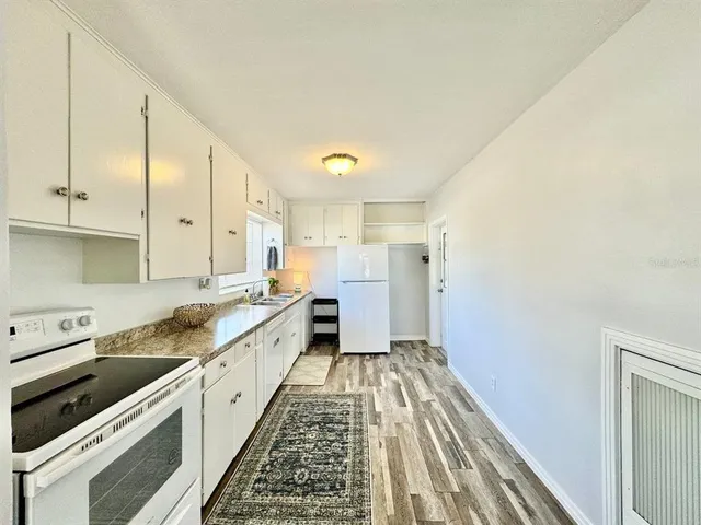 a large kitchen with a sink and cabinets