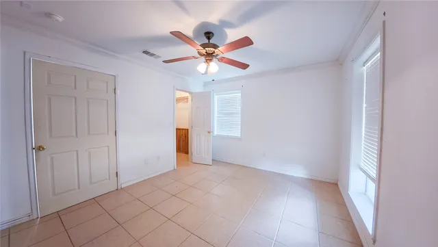 a view of a house with a yard and large tree