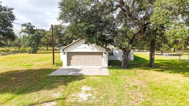 a bathroom with a granite countertop shower a toilet and sink
