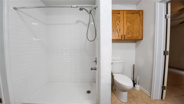 a bathroom with a shower and a mirror