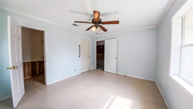 a view of a house with a yard balcony and a tree