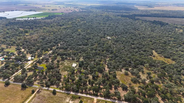 a view of a lake with beach and residential houses