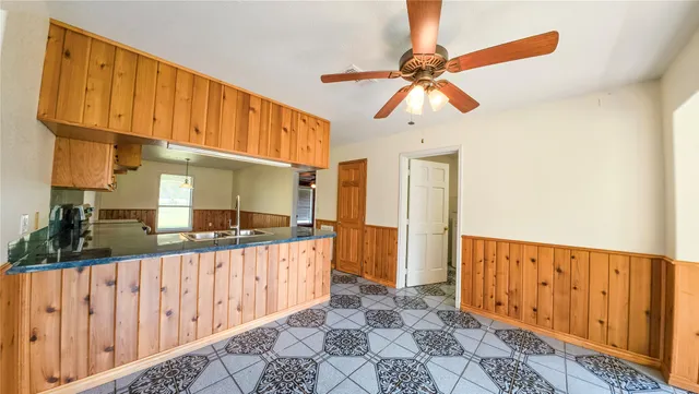 a kitchen with granite countertop a sink and a refrigerator