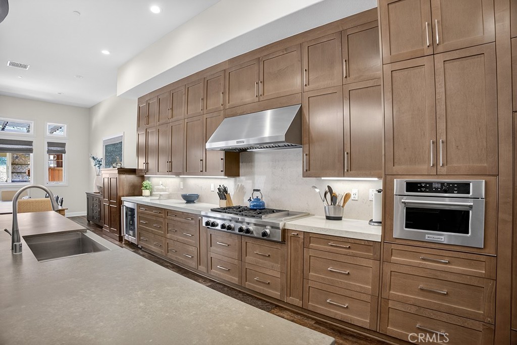 19843 Split Oak Road Chatsworth, CA 91311 - Photo 24 of 75 a kitchen with granite countertop a stove sink and cabinets