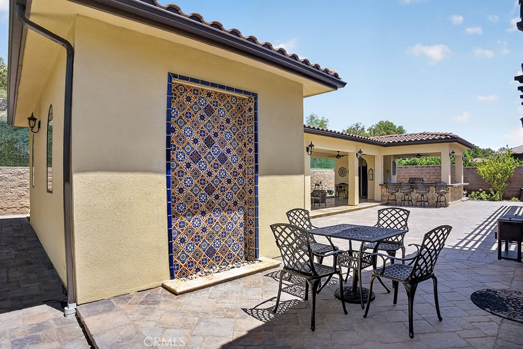 19843 Split Oak Road Chatsworth, CA 91311 - Photo 57 of 75 a view of a patio with table and chairs and potted plants