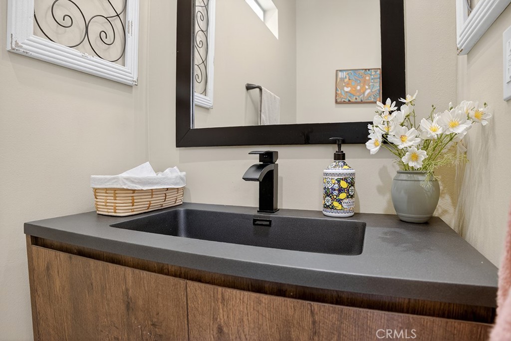 19843 Split Oak Road Chatsworth, CA 91311 - Photo 72 of 75 a bathroom with a sink and a mirror