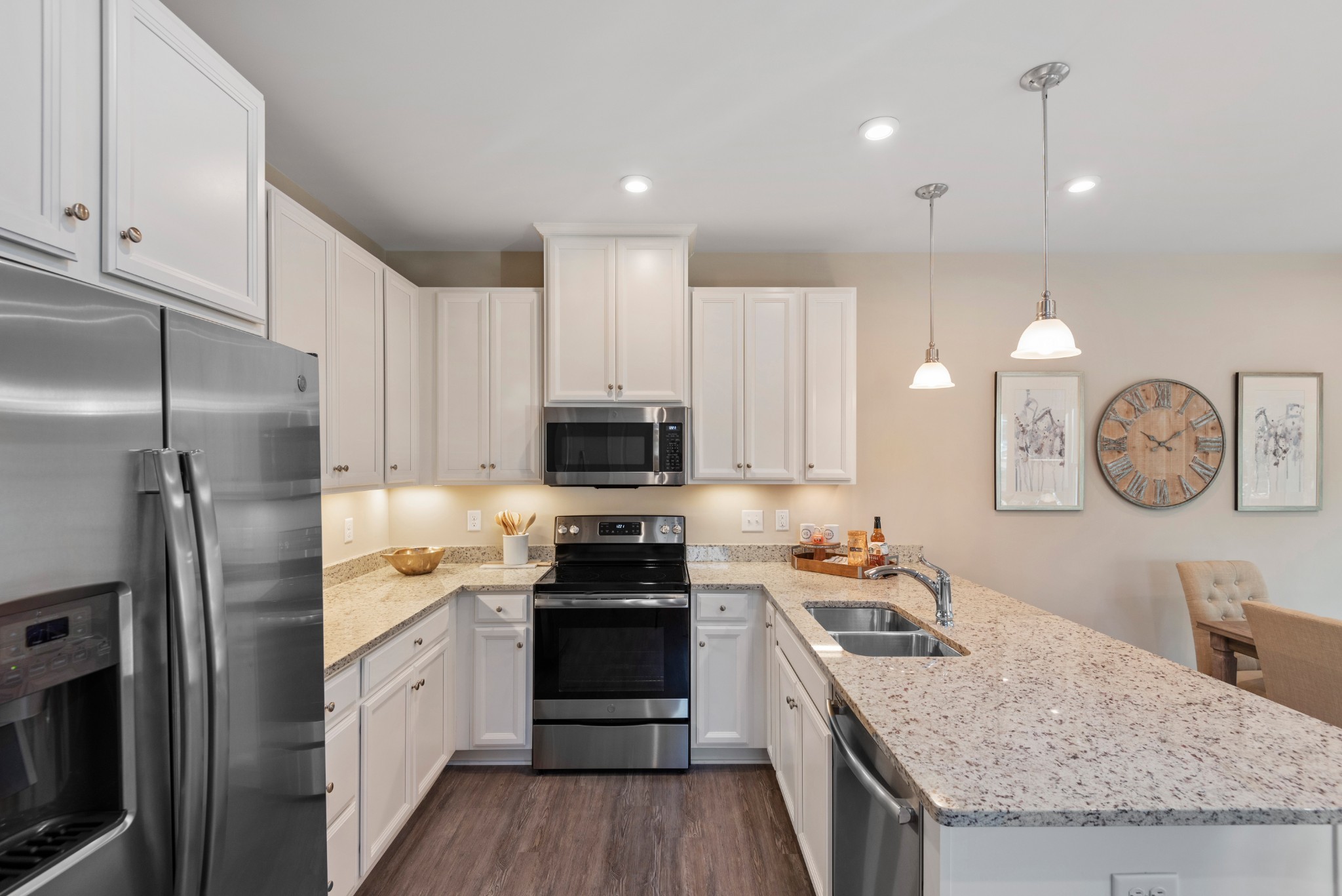 124 Keelon Gap Road, Unit 112B Spring Hill, TN 37174 - Photo 6 of 10 a kitchen with granite countertop a sink a counter space stainless steel appliances and cabinets