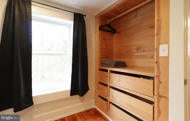 a view of walk in closet and window