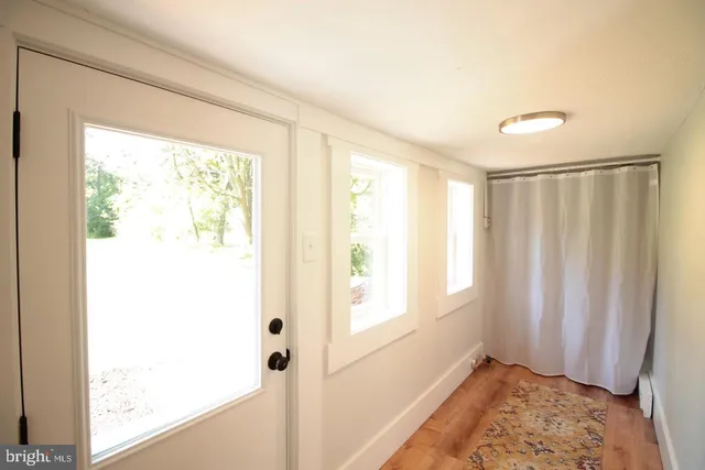 a view of a room with a window and a bathroom