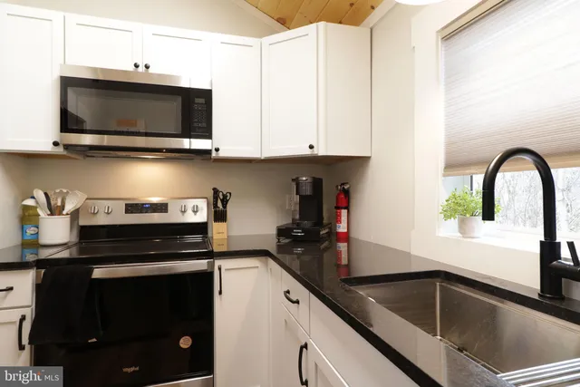 a kitchen with a sink and a stove top oven