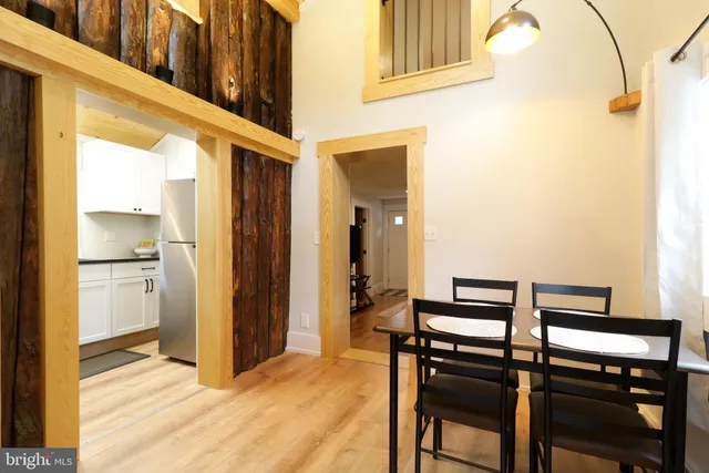 a view of a kitchen with appliances and furniture