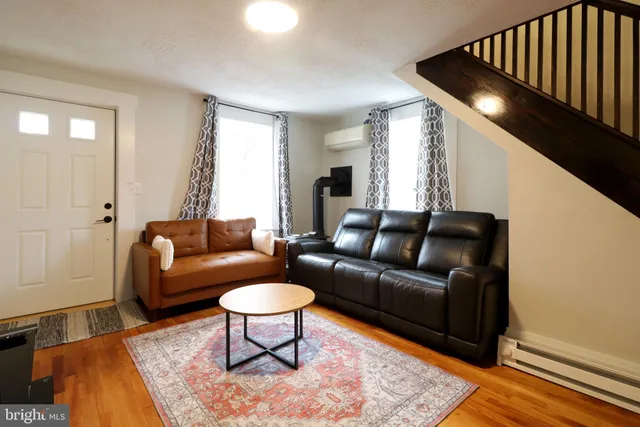 a living room with furniture and a rug