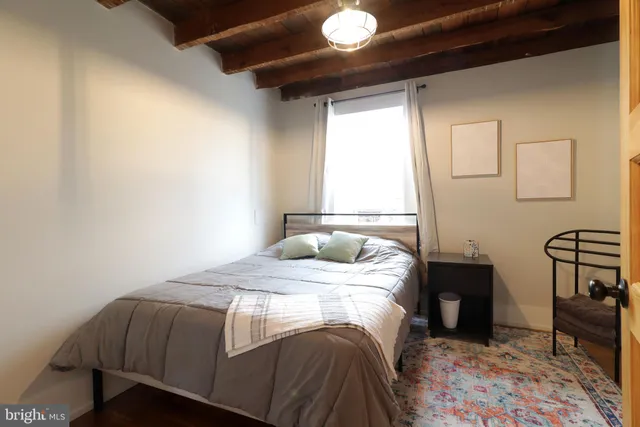 a bedroom with a bed a table and chair