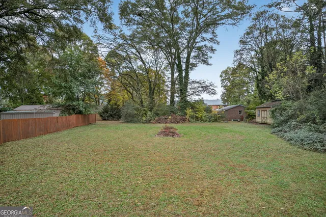 a backyard of a house with trees and entertaining space
