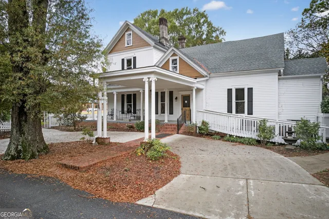 a front view of a house with garden