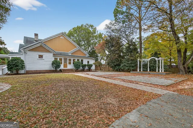a view of house with outdoor space and tree s