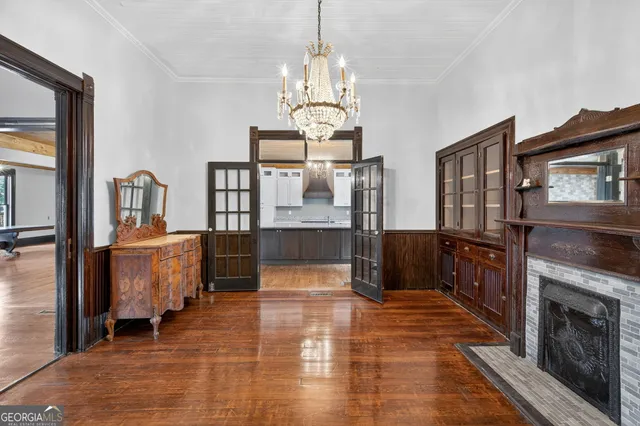 a living room with furniture a fireplace and a chandelier