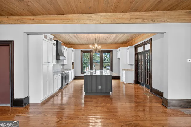 a living room with furniture wooden floor and a large window