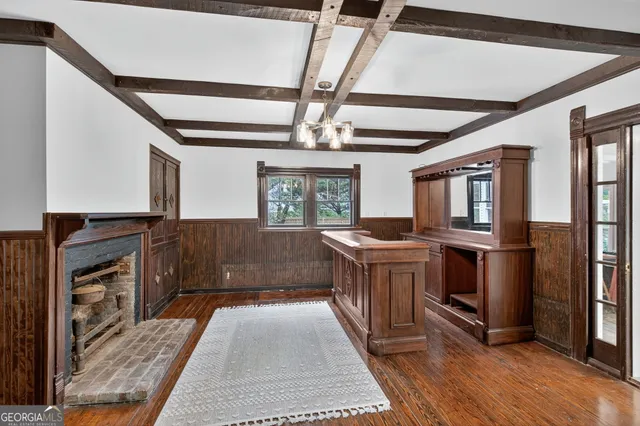 a kitchen with stainless steel appliances granite countertop a refrigerator a stove a sink dishwasher and wooden cabinets with wooden floor