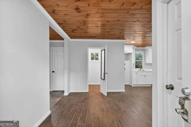 a view of a hallway with wooden floor and staircase