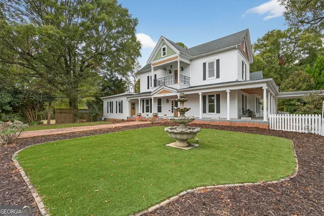 a front view of a house with a garden
