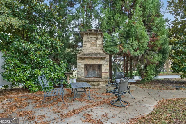 a view of a chairs and table in a backyard