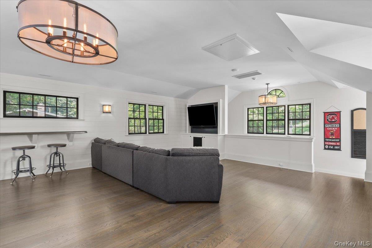 135 Pines Bridge Road Katonah, NY 10536 - Photo 17 of 40 a living room with furniture and a flat screen tv