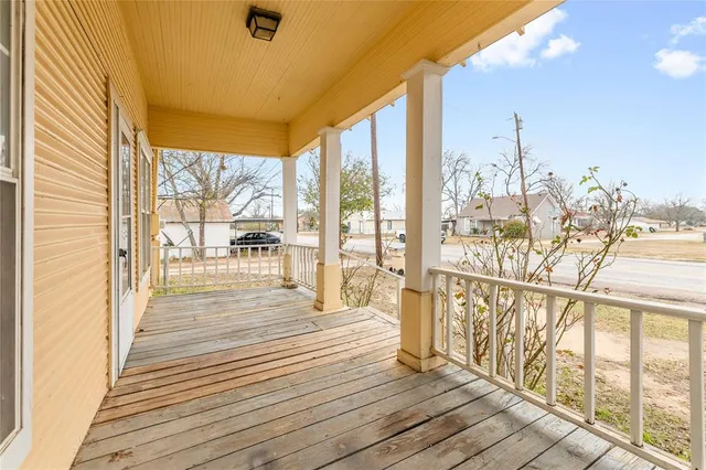 a view of a balcony with wooden floor