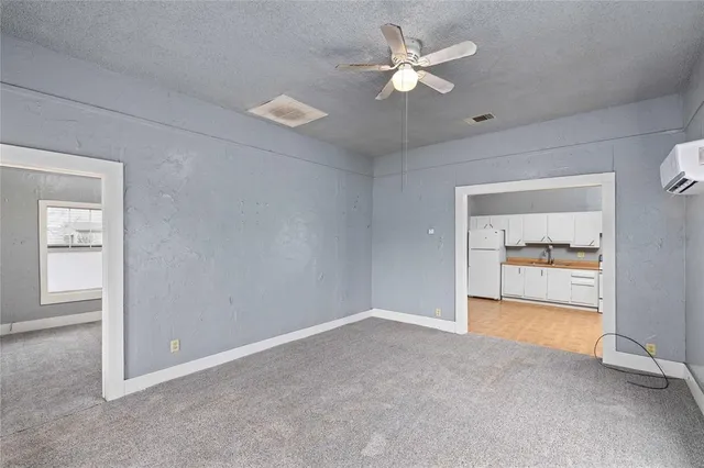 an empty room with fan and a ceiling fan