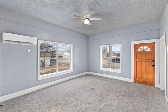 a view of an empty room with a window