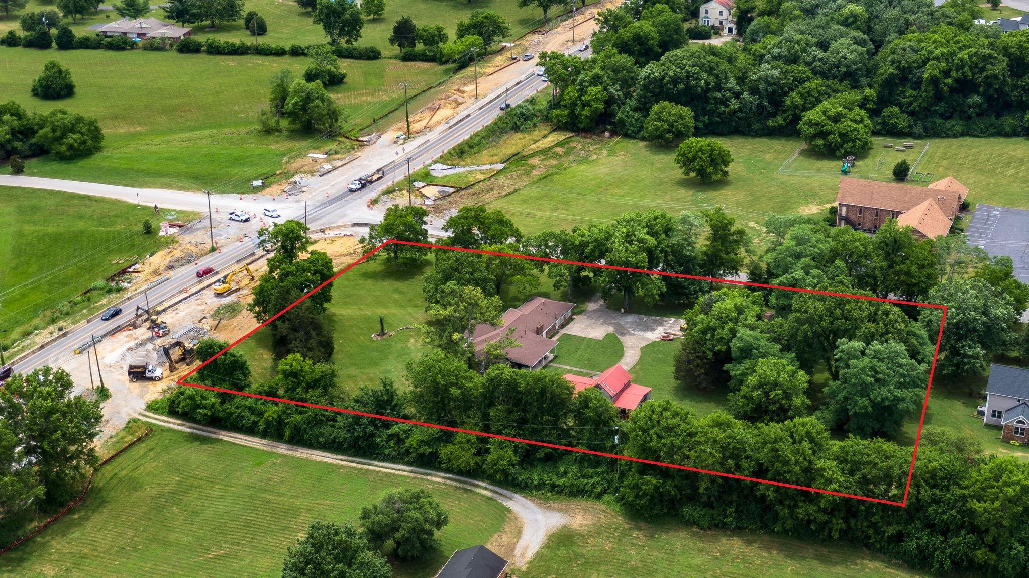 1219 Franklin Road Brentwood, TN 37027 - Photo 1 of 25 an aerial view of a house with a yard and lake view