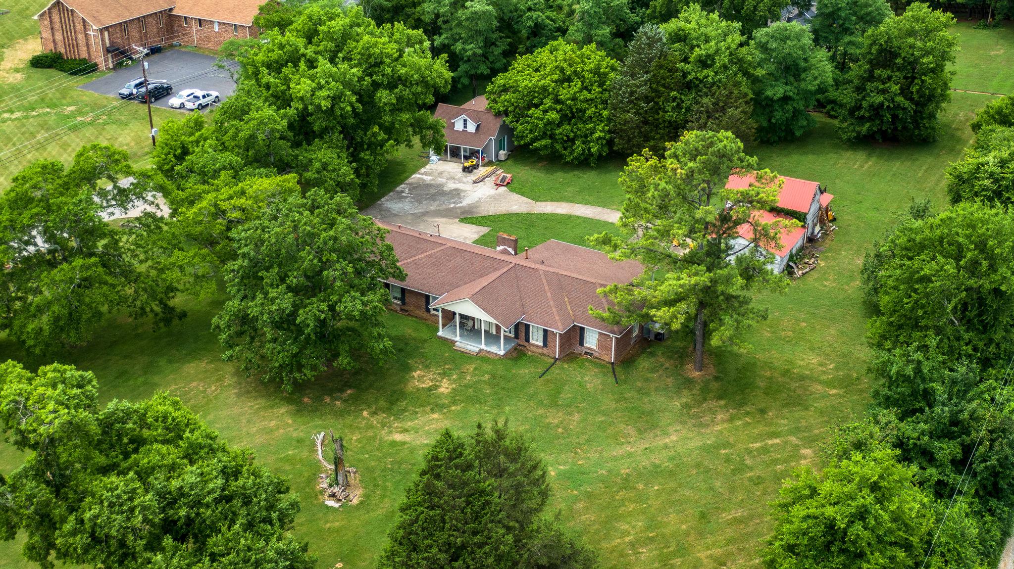 1219 Franklin Road Brentwood, TN 37027 - Photo 16 of 25 an aerial view of residential house with outdoor space and trees all around