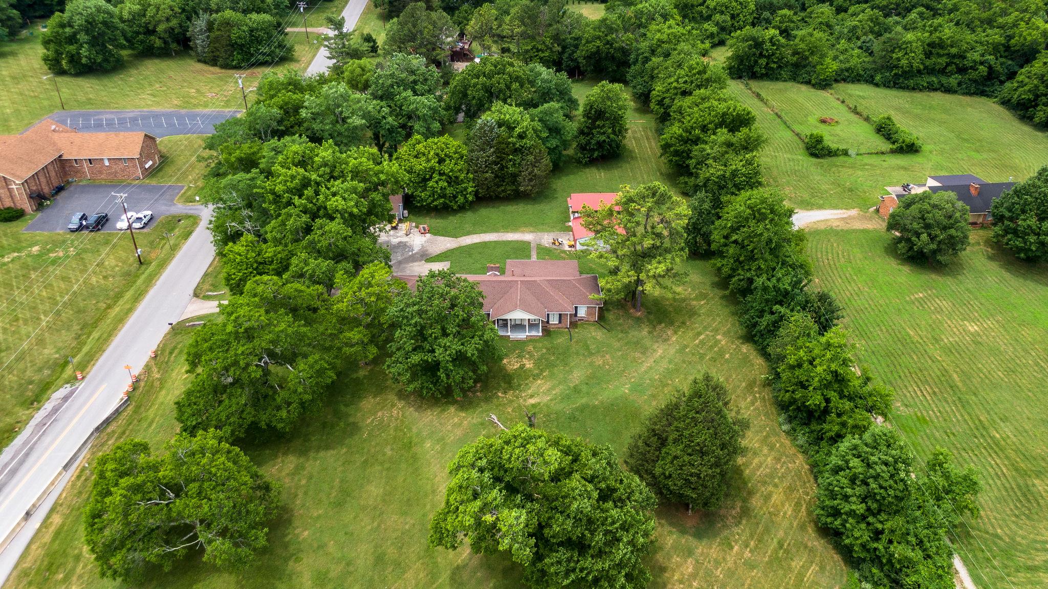 1219 Franklin Road Brentwood, TN 37027 - Photo 17 of 25 an aerial view of residential house with outdoor space and trees all around