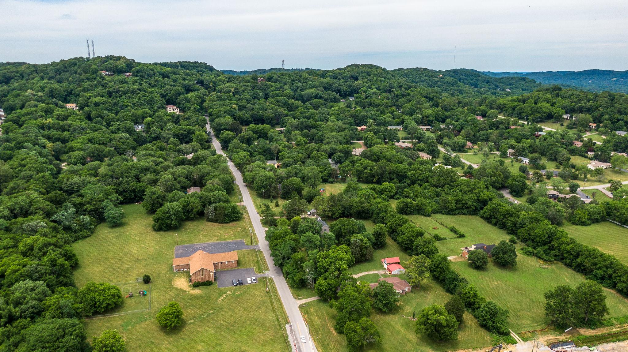 1219 Franklin Road Brentwood, TN 37027 - Photo 20 of 25 a view of a house with a lush green forest