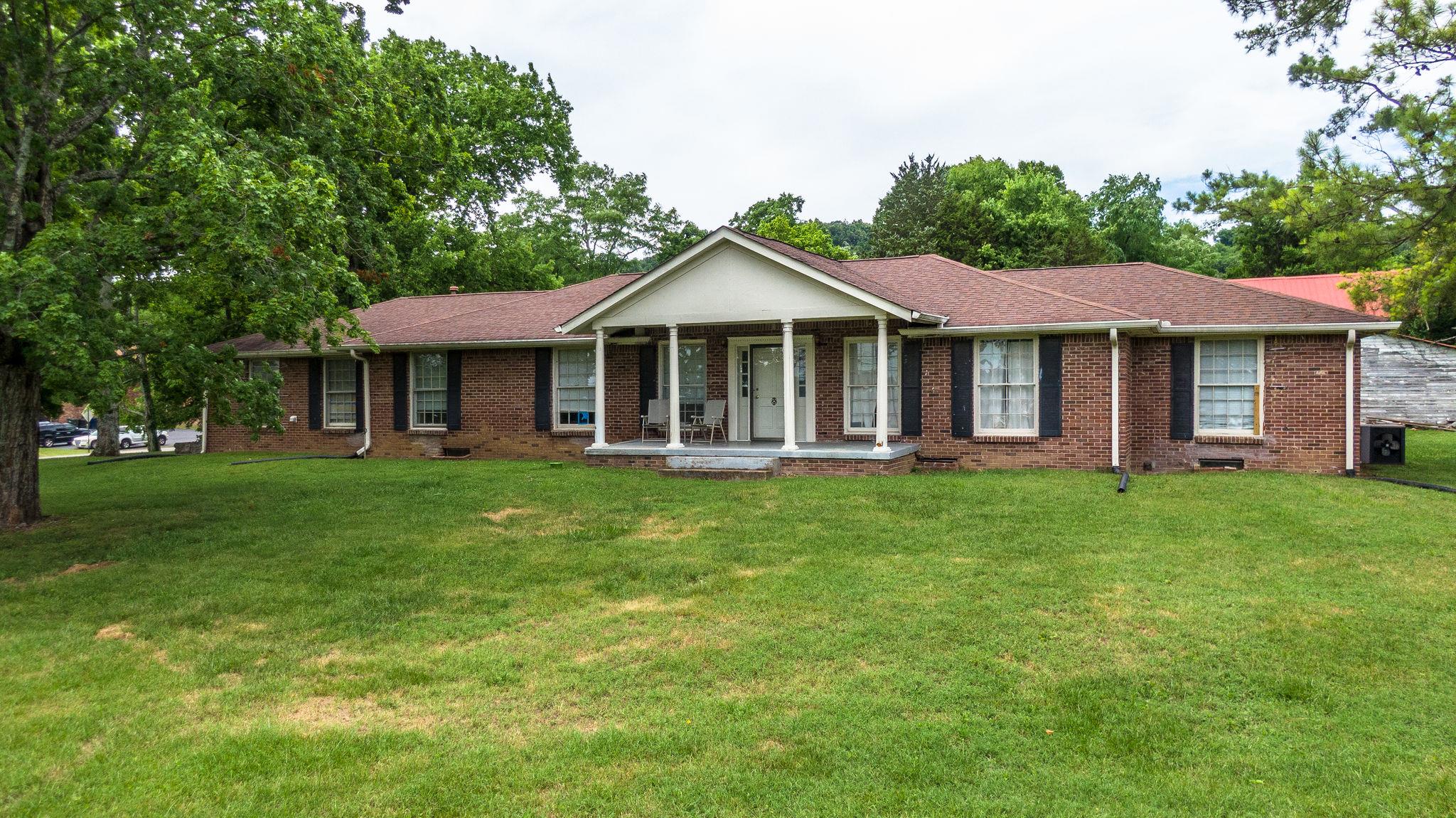 1219 Franklin Road Brentwood, TN 37027 - Photo 4 of 25 a front view of a house with a garden