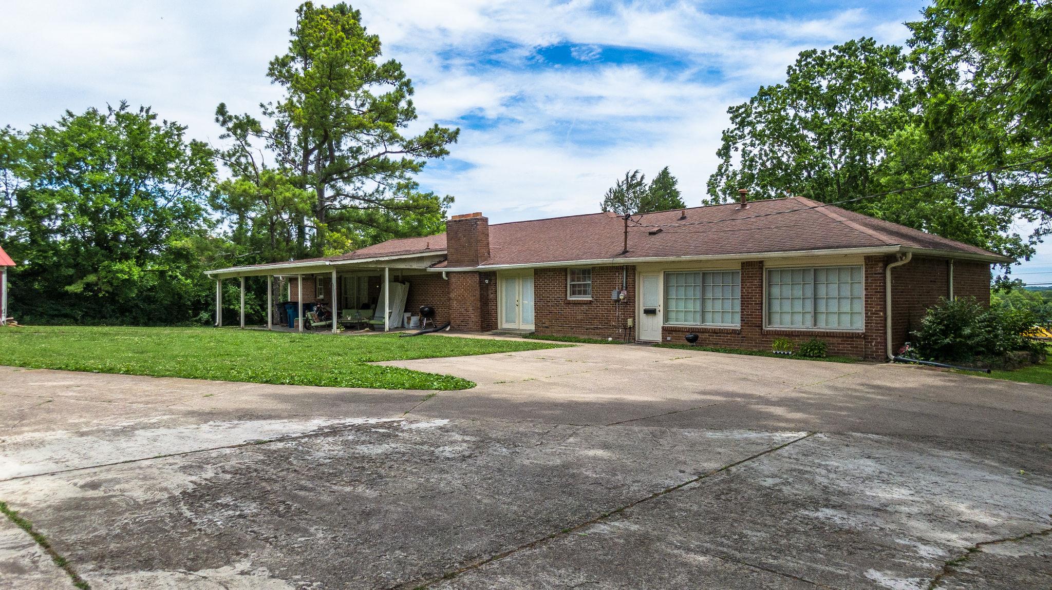 1219 Franklin Road Brentwood, TN 37027 - Photo 6 of 25 a front view of a house with a yard and garage