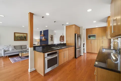 a kitchen with stainless steel appliances granite countertop a stove and a refrigerator