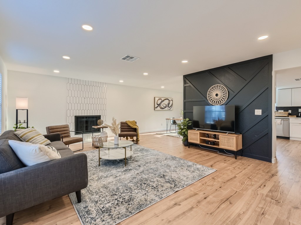 a living room with furniture and a wooden floor