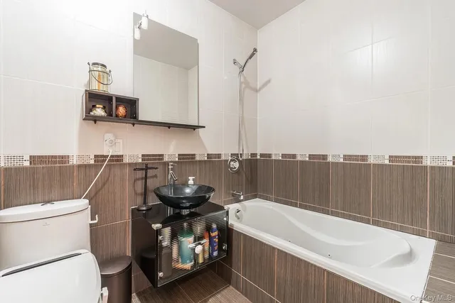 a bathroom with a sink a toilet and a bathtub