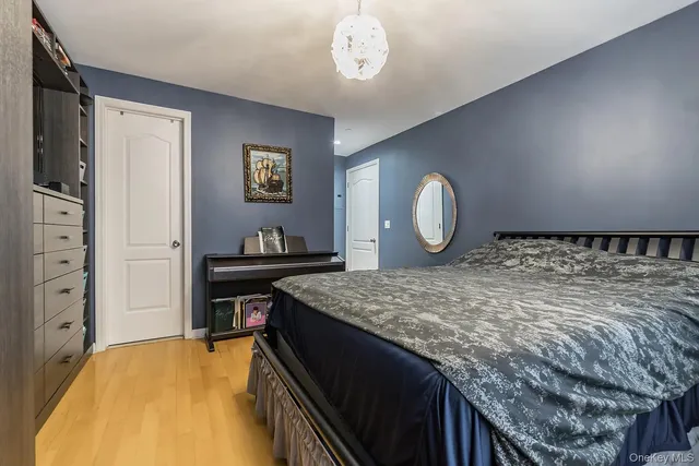 a bedroom with a bed and cabinet