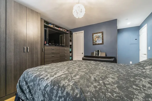 a bedroom with a bed and a television