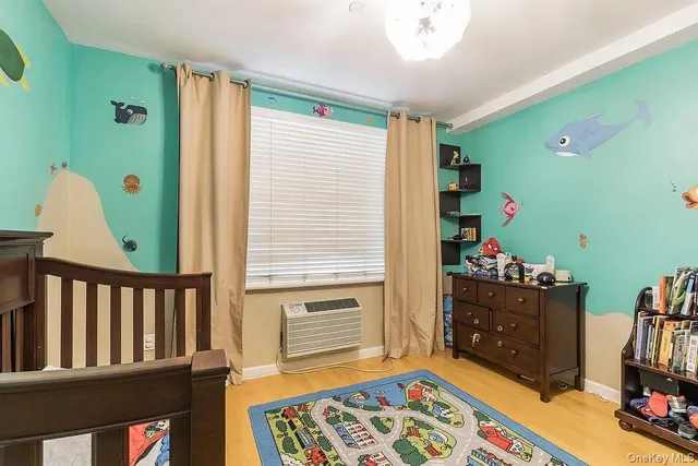 a bedroom with furniture and a book shelf