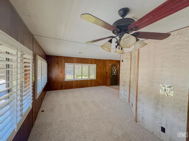 a view of a hallway with a chandelier fan
