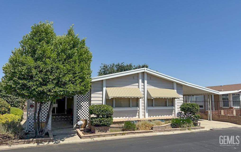 Undisclosed Address Bakersfield, CA 93306 - Photo 2 of 41 a front view of a house with a yard